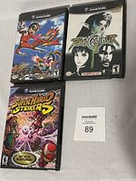 Three Nintendo GameCube game cases (Viewtiful Joe 2, Soul Calibur II, Super Mario Strikers) arranged flat on a surface with MaxSold tag.