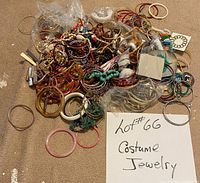 A cluttered pile of assorted costume jewelry consisting mostly of bracelets and necklaces in various colors and materials.