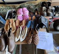 Nine pairs of women's shoes displayed on a table with a handwritten note 'Lot #17 Assortment Shoes Size 6 1/2'. Shoes include a variety of styles and materials such as leather, suede, woven, fuzzy material, and printed fabric.