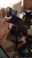 Bench grinder setup with Power Fist grinder on Mastercraft stand in basement environment.