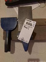 Top view of the anvil with attached note and the adjacent scraper tool.