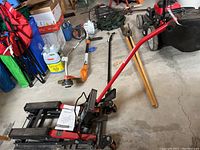 Side view of the motorcycle jack showing frame, lift arms, pump handle and manual