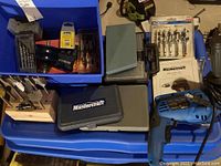 Blue plastic drill, Mastercraft case, bit sets on a blue tote