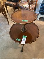 Full view of vintage 2 tier wooden pie table showing both tiers with scalloped edges and central turned column.