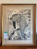 Full view of framed Asian bird print artwork showing peacock and background details.