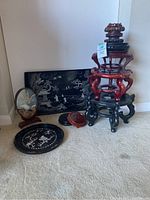 Overall view of trays, framed art and stacked wood stands on carpet