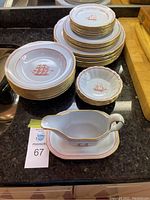 Full set stacked showing dinner plates, soup bowls, multiple smaller plates, and a gravy bowl with plate