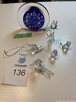Full lot overview showing the five small animal crystal figures and the round glass paperweight.