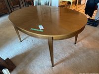 Side angle showing wood grain and tapered legs