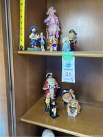 Overall view of figurines on two shelves, showing size and placement