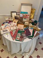 Full table view of assorted stationery and gift items including cards, bags, boxes, and tissue paper.