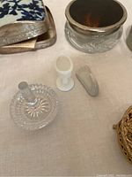 Photo showing several small vintage decorative items and a small fabric piece in a frame.