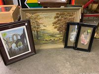 Photo shows all four pieces: large framed oil painting in center, James Limbers print on left, and two smaller oval framed prints on right
