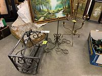 Overview of all three items: metal candlestick holder, metal votive holder, and metal magazine rack arranged on floor showing size and design details.