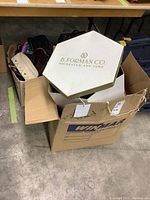 Box labeled WINMAR containing a white B. Forman Co. Rochester NY hat box and several purses and totes around it.