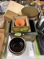 Image showing a variety of wood boxes stacked with a ceramic planter inside one, along with other items visible on table
