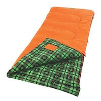 Orange Coleman Granite Peak sleeping bag open to show green plaid fleece lining with black emoji-like designs, quilted padding on the orange exterior, zipper side visible.