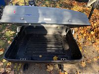 Open gray Voyageur car travel carrier showing interior base and mounting hardware