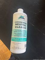 Close-up photo of one white plastic bottle labeled Concentrated Neutral Cleaner.