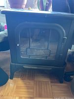 Front view of Century electric stove style fireplace showing design and condition