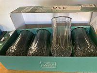 Set of four crystal glass tumblers in original box showing overall condition and packaging.