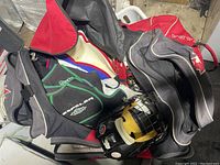 Multiple hockey bags with gear visible, black and red color schemes, various brands shown including Propeller and CCBA.