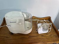 Full view of Honeywell humidifier and white mini chopper on wooden surface