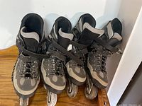 Two pairs of men's rollerblades side by side, showing front and top view with laces and straps.