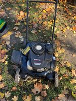 Front view of the Yard Machine lawnmower showing overall condition and design with a rear discharge chute.