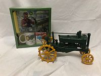 Photo of the John Deere heavy cast iron tractor and the holiday gift set in original packaging with mug, notebook, and Neslte mix