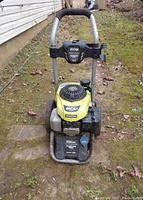 Front view of Ryobi 3000 PSI pressure washer showing yellow Honda engine and frame.