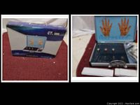 Open metal carrying case showing the CT Ion device with knobs and hand diagrams displayed inside the lid, along with the instruction materials on the side.