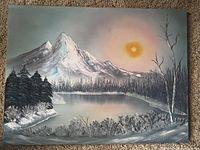 Full view of the 18x24 inch canvas painting showing an Alaskan landscape with mountains, lake, trees, and sun.