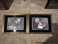 Shows both framed religious prints side by side on carpeted floor.