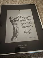 Framed black and white print of Gary Player mid-swing with quote and signature, showing overall condition and presentation.