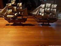 Wooden reproduction ships placed on floor showing size and form