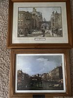 Two framed prints: top is a street scene with stone bridge and horse-drawn carriages, bottom is a Venetian canal scene with gondolas.