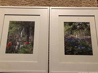 Two framed garden scene prints by ET Funk side by side showing red and blue flowers
