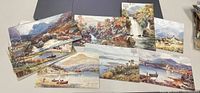 Photo showing several antique Tuck's postcards laid out to display scenic watercolor views of Scottish landscapes including mountains, rivers, waterfalls, and lakes.
