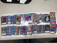 Spread of multiple stacks of Yu-Gi-Oh! cards showing the variety and quantity in the lot.