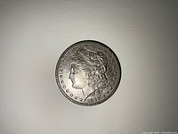 Front (obverse) side of the 1879 Morgan Silver Dollar showing Lady Liberty's profile and inscriptions.