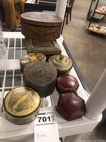 Overview of the 8 assorted trinket boxes displayed on a shelf, showing diversity in shape, size, and design.