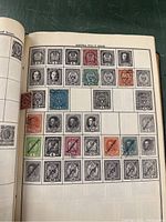 Page of the album showing Austrian stamps from 1916-19 issues, featuring various denominations and colors, some with cancellation marks.