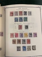Page from stamp book showing New Zealand stamps from various years including 1874, 1875, 1876, 1882, and early 1900s with multiple colors and postmarks.