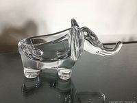 Clear crystal elephant figurine photographed from side showing detailed shape and dimensions.