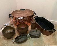 Overview of all seven copper and brass items grouped on floor