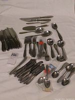 Full spread of flatware pieces arranged on white background