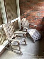 Rocking chair at left, Adirondack lounge chair with integrated footrest at right, side table visible between chairs