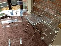 Overview of four chairs, two TV tables, bar cart, and clothing rack