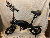 Unfolded bike showing frame, wheels, seat and handlebar